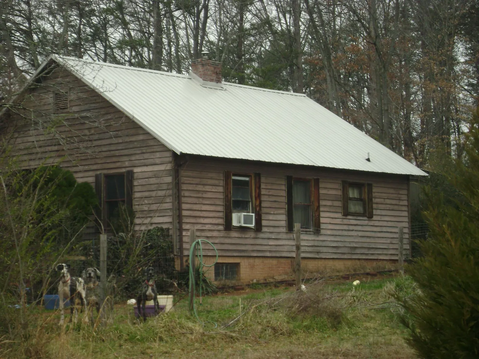 White metal roof on an old wood sided farmhouse, from a Metal Roof Installation job in Shelton
